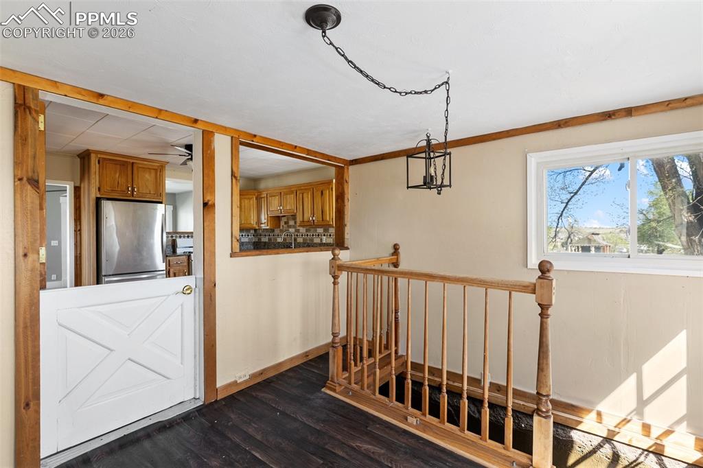 10355 Link Road Fountain, CO 80817 - Photo 12 of 45 a view of a hallway with wooden floor and staircase