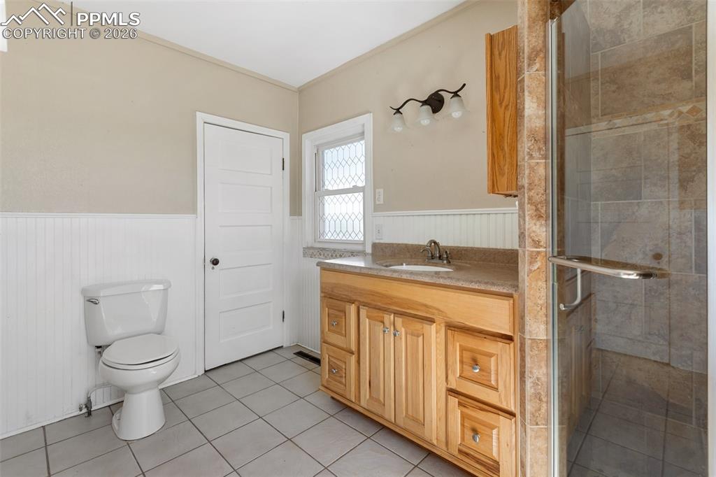 10355 Link Road Fountain, CO 80817 - Photo 16 of 45 a spacious bathroom with a granite countertop sink toilet and shower