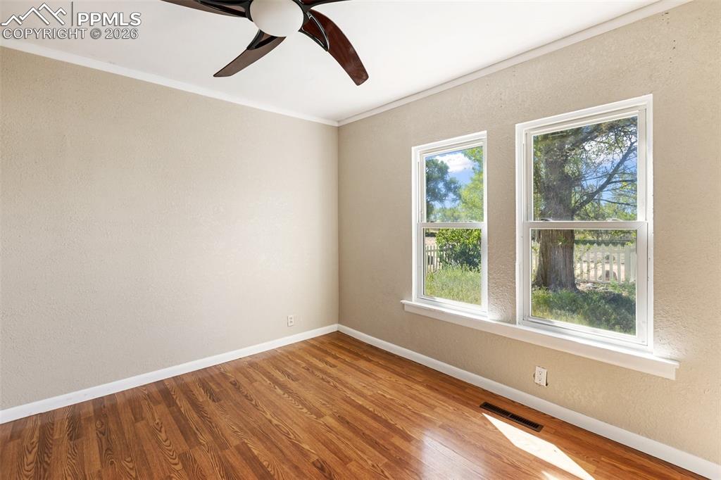 10355 Link Road Fountain, CO 80817 - Photo 29 of 45 a view of an empty room with wooden floor and a window