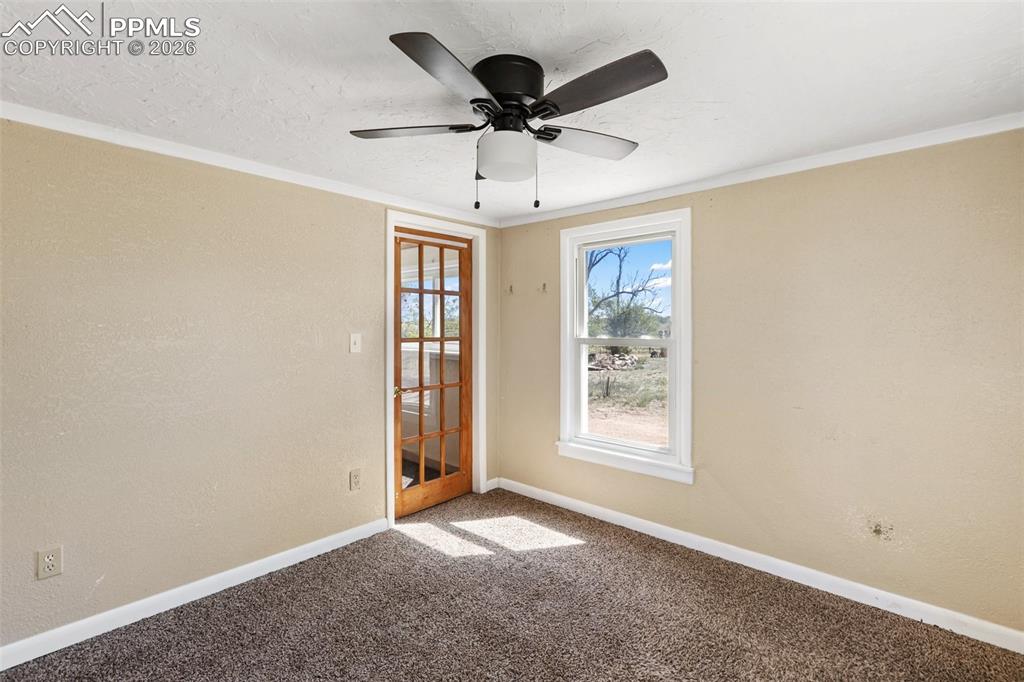 10355 Link Road Fountain, CO 80817 - Photo 32 of 45 an empty room with windows and ceiling fan