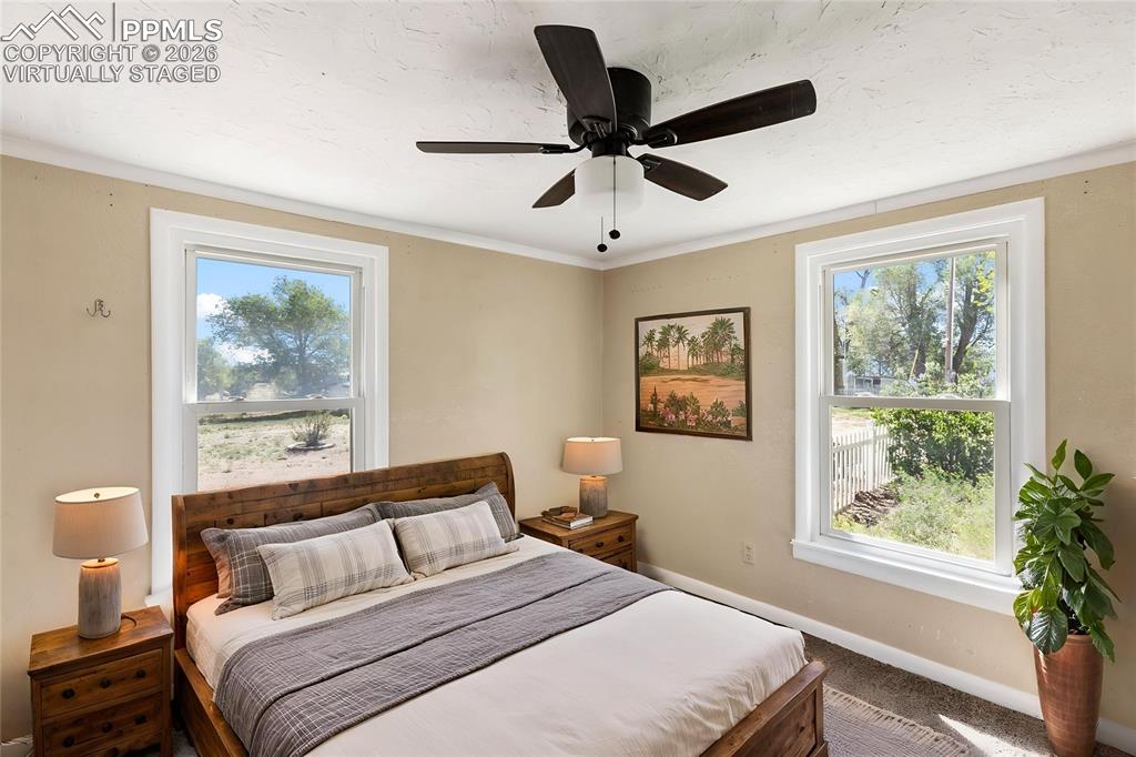 10355 Link Road Fountain, CO 80817 - Photo 33 of 45 a bedroom with a large bed and a window