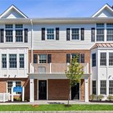 a front view of a residential apartment building with a yard