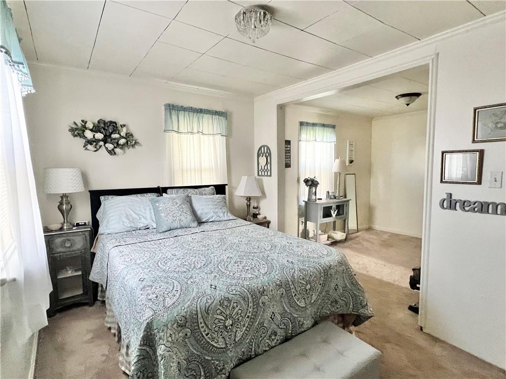 1480 Harvey Run Road Freedom, PA 15042 - Photo 23 of 26 a spacious bedroom with a bed and a chandelier