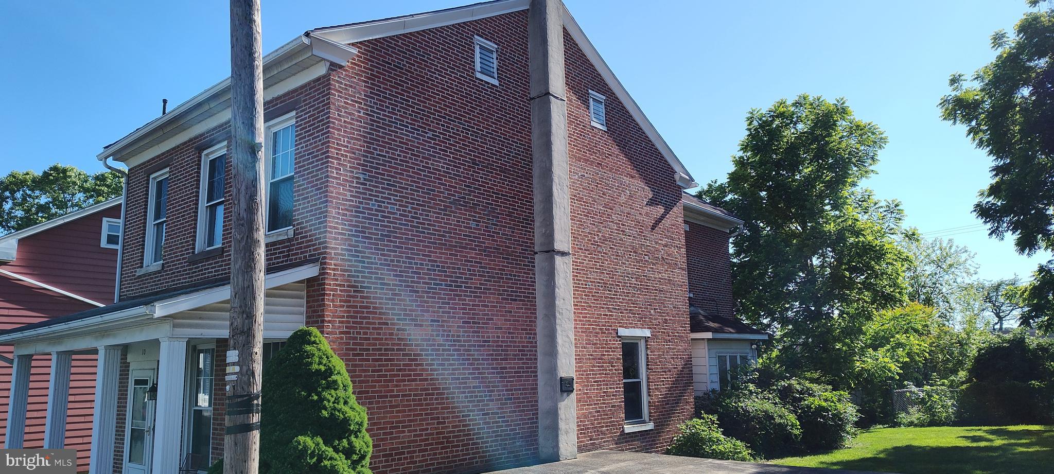 10 South 3rd Street Mifflintown, PA 17059 - Photo 3 of 9 a brick building with a large windows