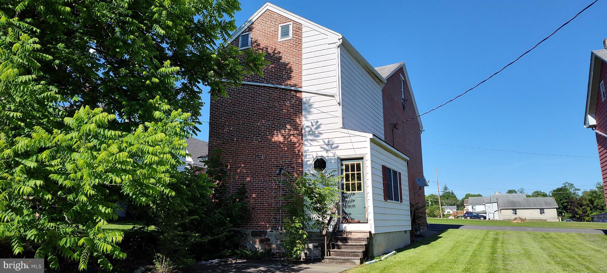 10 South 3rd Street Mifflintown, PA 17059 - Photo 4 of 9 a view of a tall brick building next to a yard