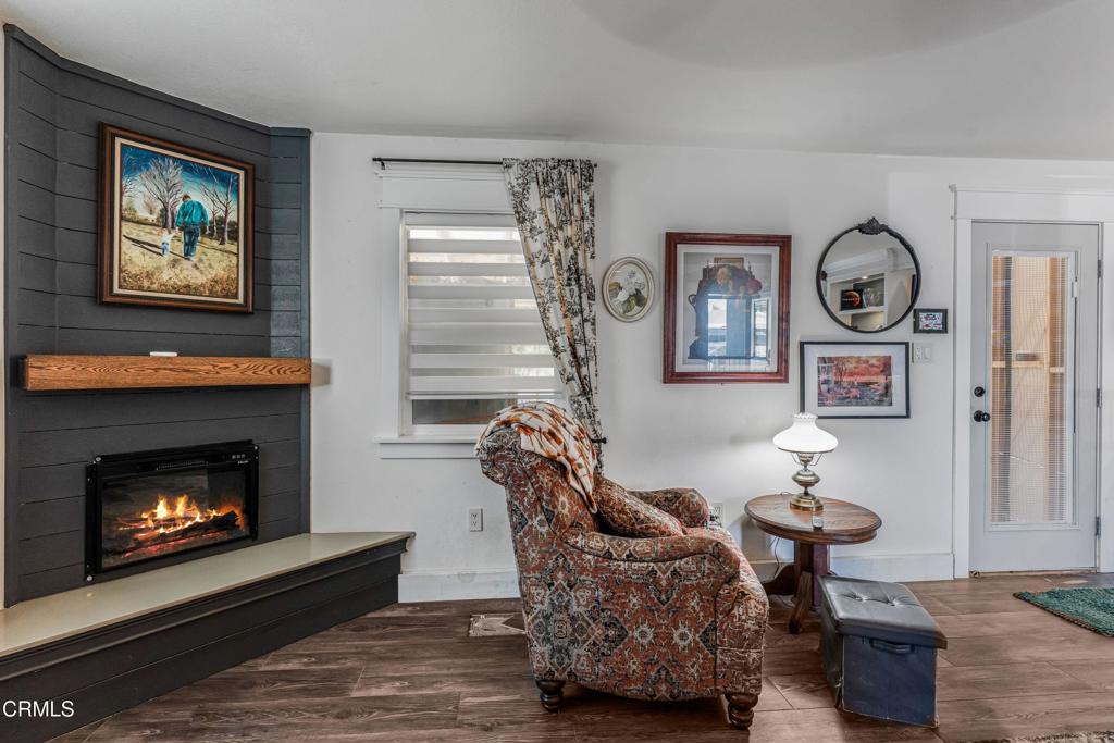 3290 Cole Avenue Simi Valley, CA 93063 - Photo 3 of 24 a living room with furniture a window and a fireplace