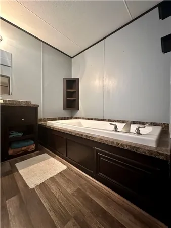 a bathroom with a granite countertop sink a toilet and a mirror