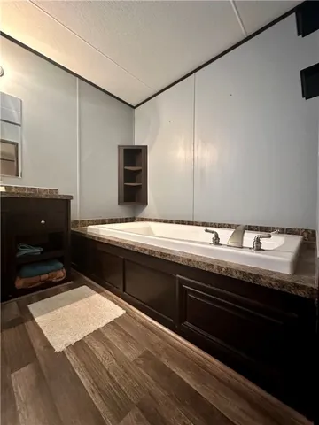 a bathroom with a granite countertop sink a toilet and a mirror