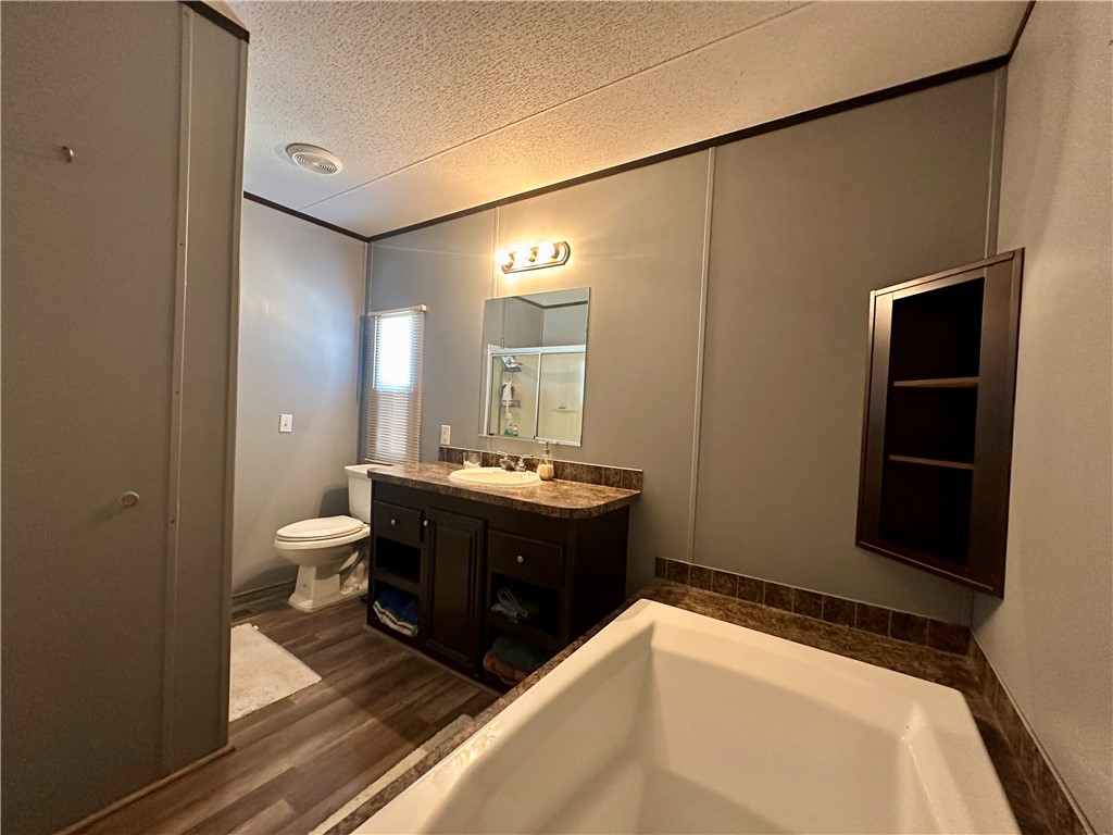 1708 Hill Street Sandia, TX 78383 - Photo 13 of 16 a spacious bathroom with a sink mirror vanity and toilet