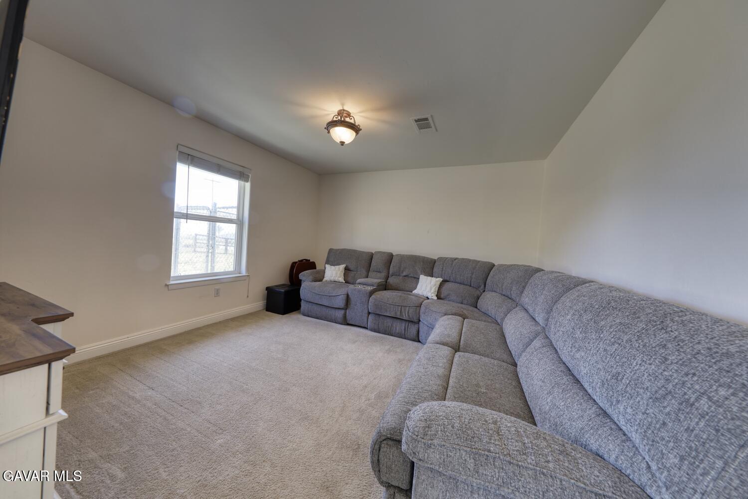 24500 Jacaranda Drive Tehachapi, CA 93561 - Photo 19 of 45 a living room with furniture and a window