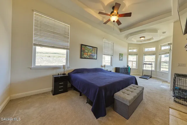 a bedroom with a large bed and a fireplace