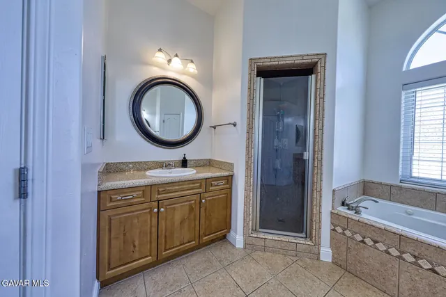 a spacious bathroom with a tub and a window