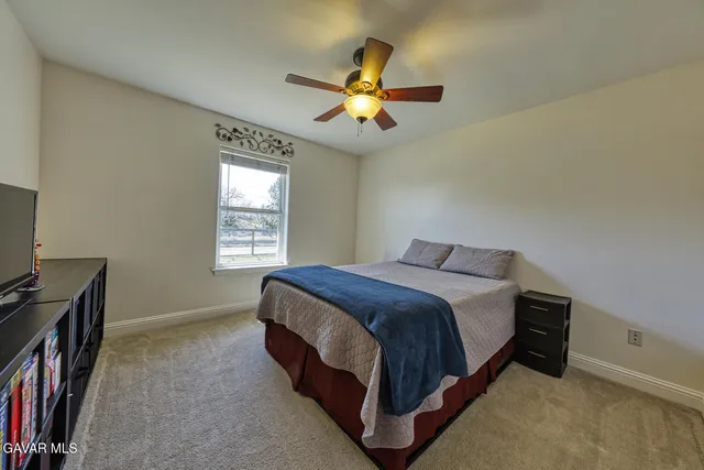 a bed room with a bed and a television