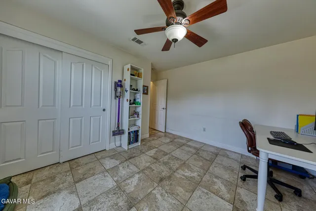 a bathroom with a granite countertop sink a mirror and a toilet
