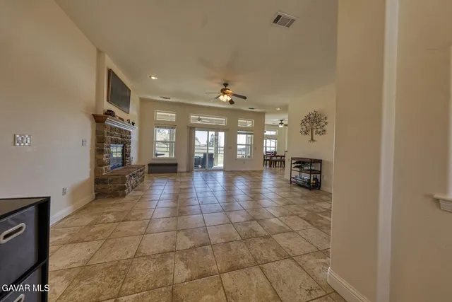a hallway with a large window and a fireplace
