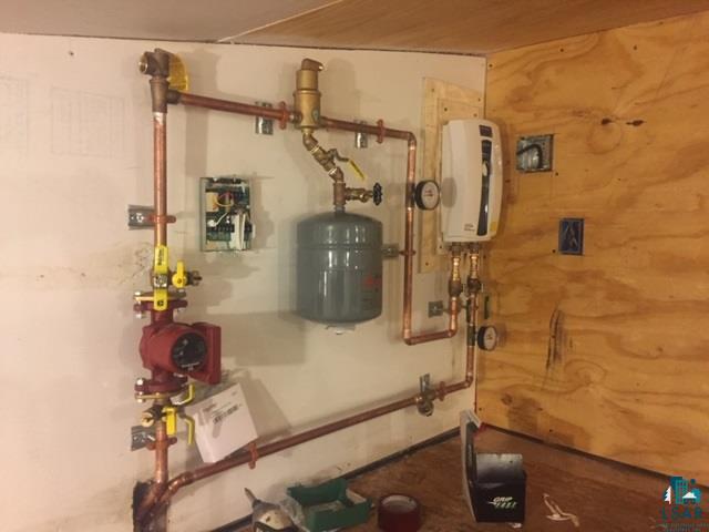 5918 Jean Duluth Road Duluth, MN 55803 - Photo 32 of 34 The boiler for the on demand hot water in floor heat for the addition is above the new addtion.