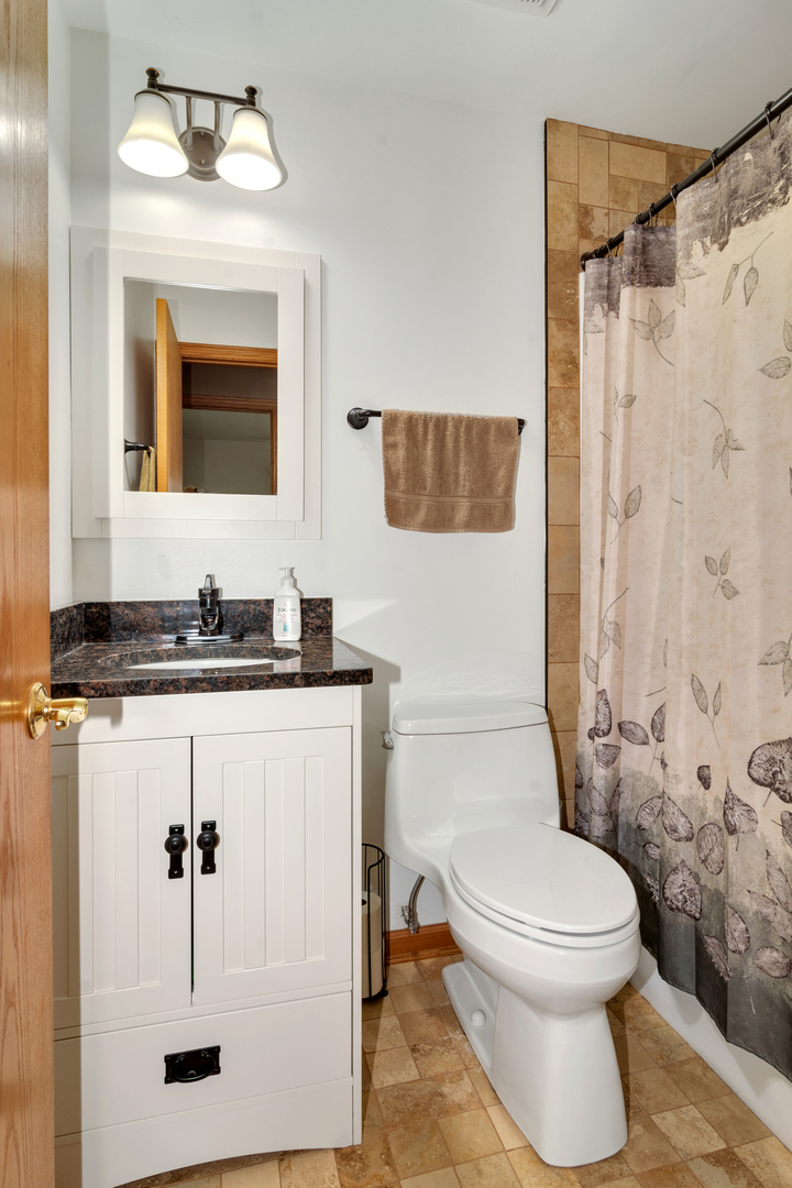 72 Marnel Road Montgomery, IL 60538 - Photo 15 of 26 a bathroom with a granite countertop sink toilet a mirror and shower