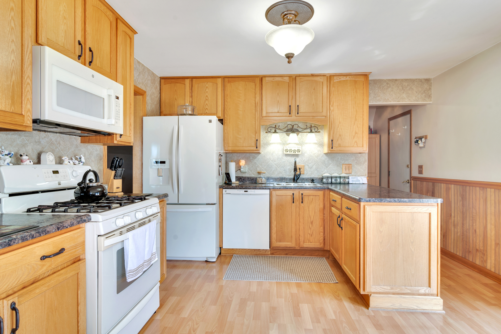 72 Marnel Road Montgomery, IL 60538 - Photo 6 of 26 a kitchen with stainless steel appliances granite countertop a refrigerator a stove and a sink with large window