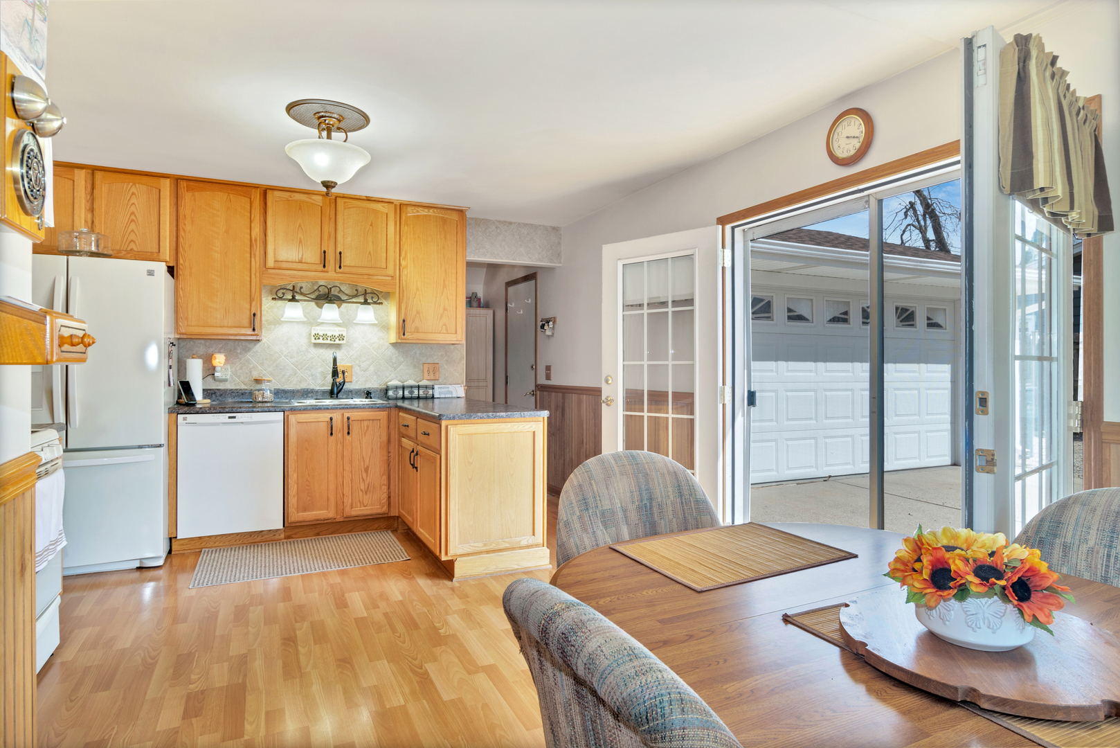 72 Marnel Road Montgomery, IL 60538 - Photo 8 of 26 a kitchen with stainless steel appliances granite countertop a refrigerator a sink dishwasher and white countertops with wooden floor