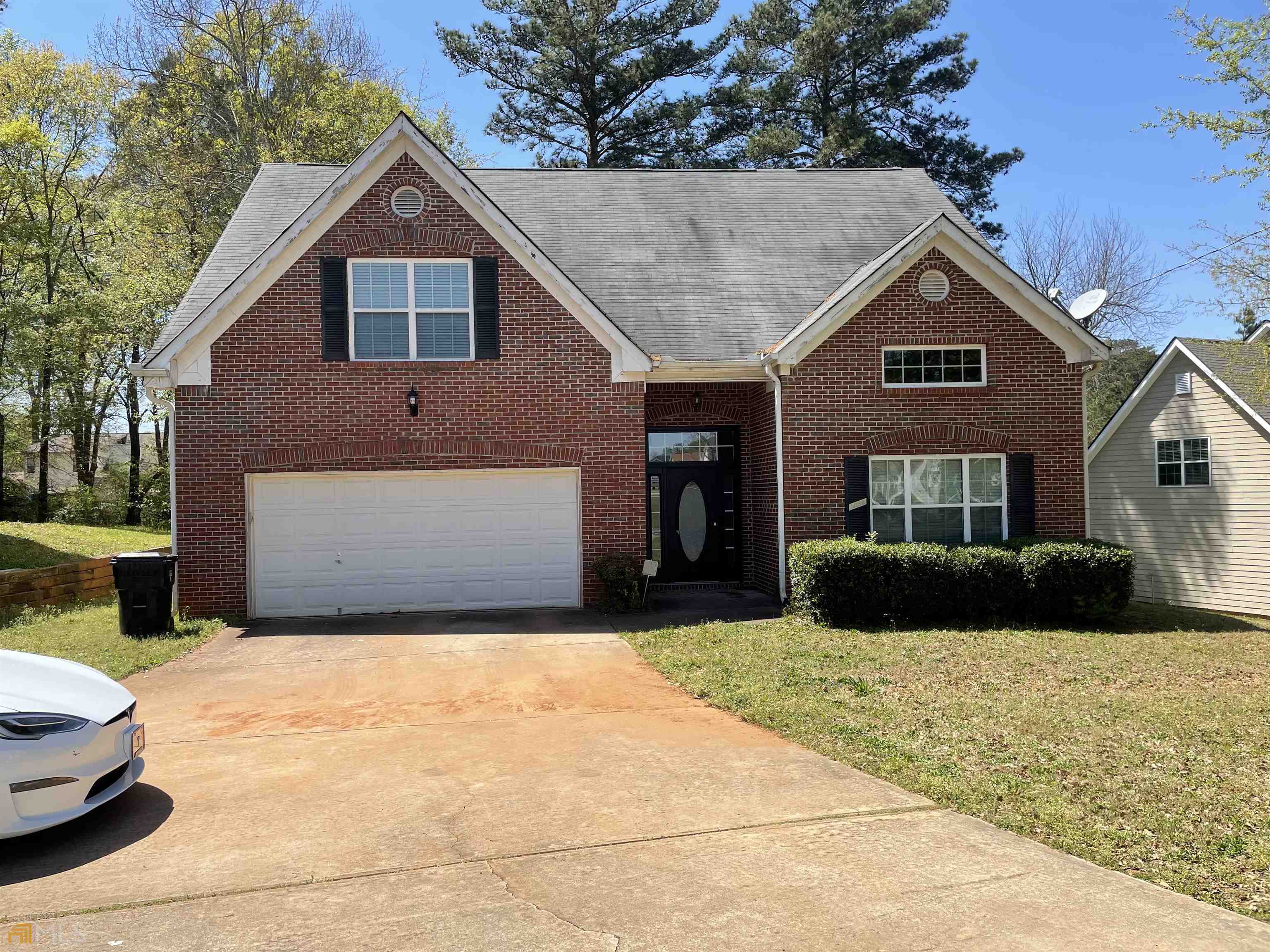 7495 Conkle Road Jonesboro, GA 30236 - Photo 1 of 1 a front view of a house with a yard and garage