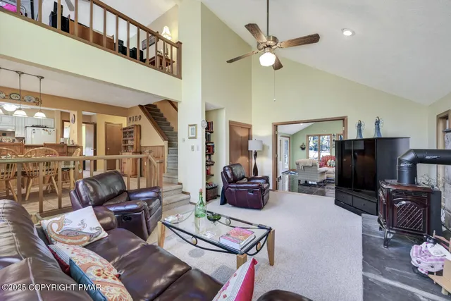 a dining room with furniture a chandelier and wooden floor