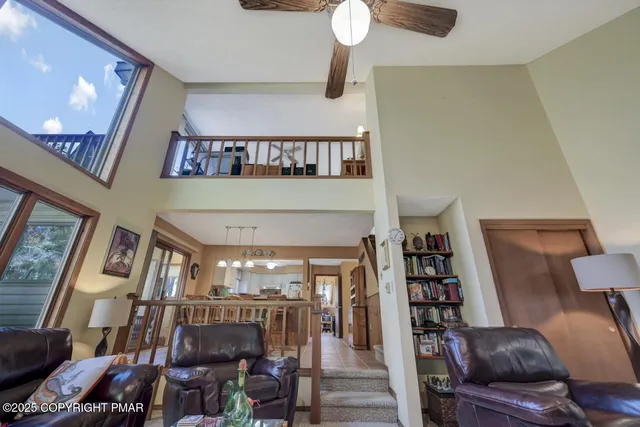 a living room with furniture and a floor to ceiling window