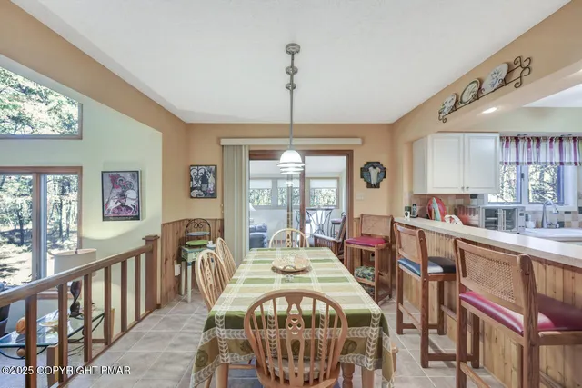 a kitchen with a refrigerator a stove top oven a clock and a window