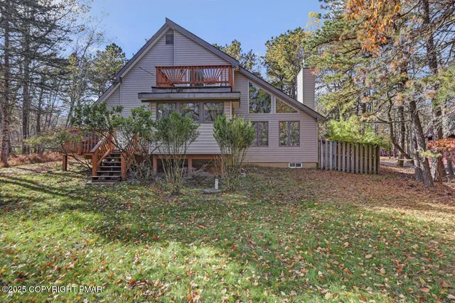 a living room with furniture ceiling fan and a rug