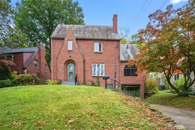 a front view of a house with garden