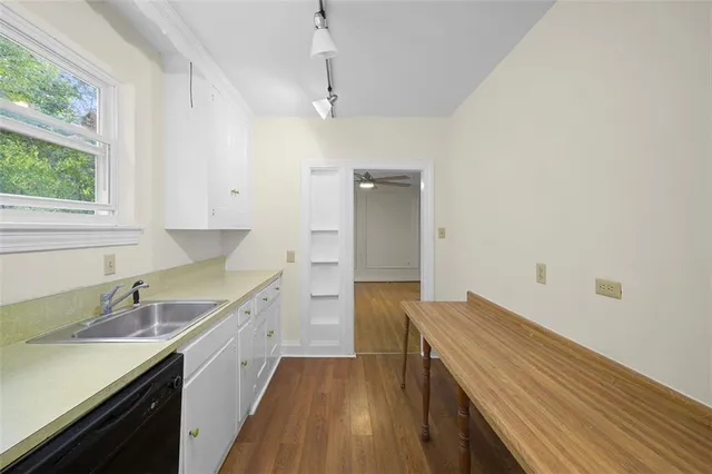 a kitchen with a sink stove and cabinets