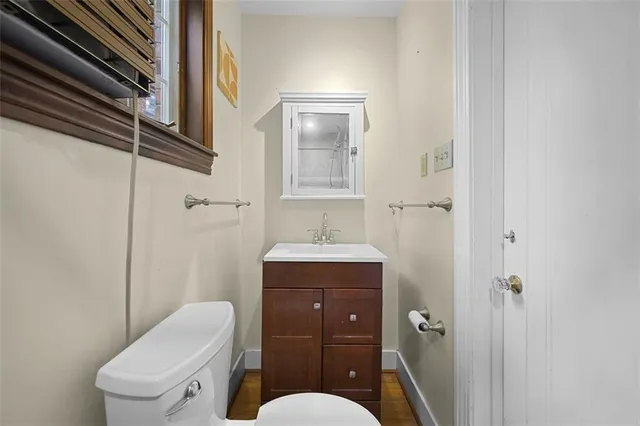 a bathroom with a toilet a sink and mirror