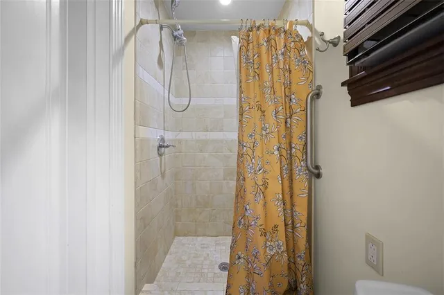 a bathroom with a shower and a mirror