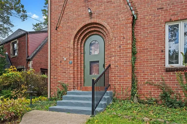 a view of a brick house with plants