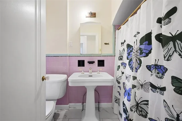 a bathroom with a sink mirror and vanity
