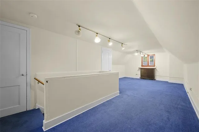 an empty room with wooden floor and white walls