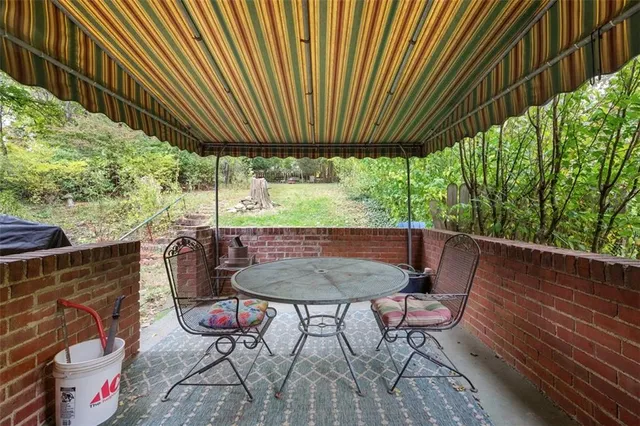 a view of a chairs and table in the patio