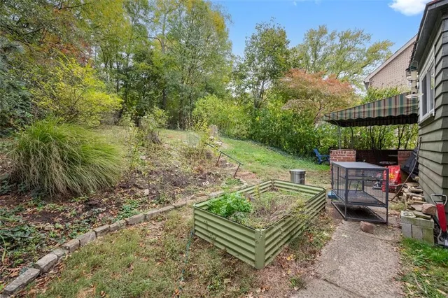 a view of a chair and table in the garden