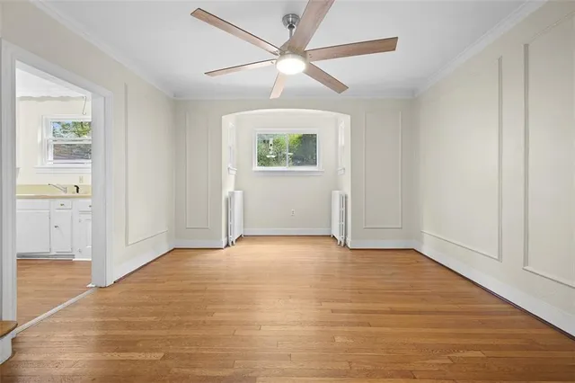 an empty room with fan and windows