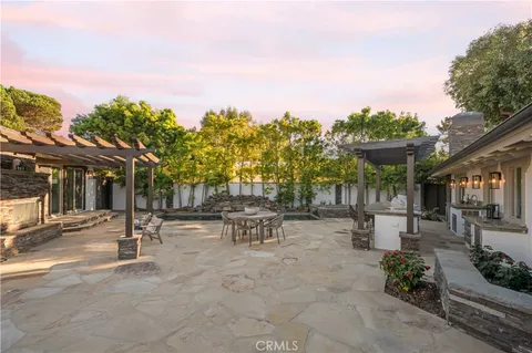 a row of palm trees in front of house