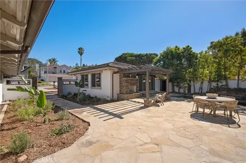 a view of a house with yard and sitting area