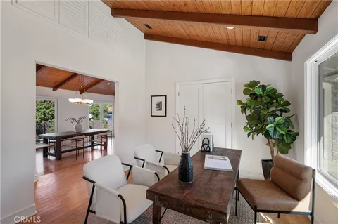a dining room with furniture and wooden floor