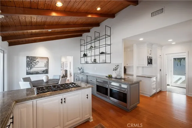a kitchen with stainless steel appliances granite countertop a stove and a refrigerator