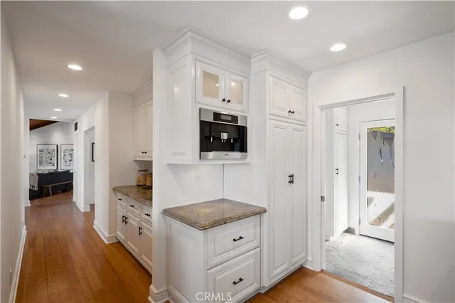 a kitchen with a refrigerator and a sink
