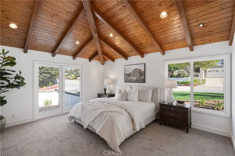 a bathroom with a double vanity sink a mirror and a bathtub