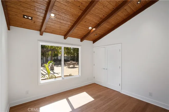 a bedroom with a large bed and a potted plant