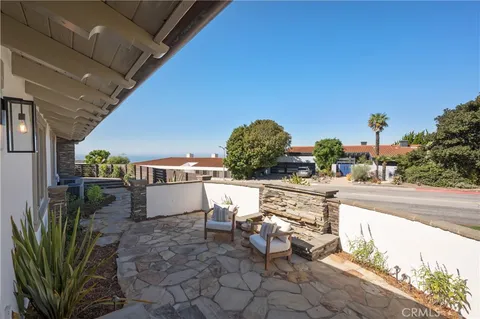 an aerial view of a house with garden space and street view