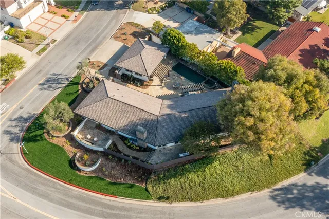 an aerial view of a house with garden space and street view