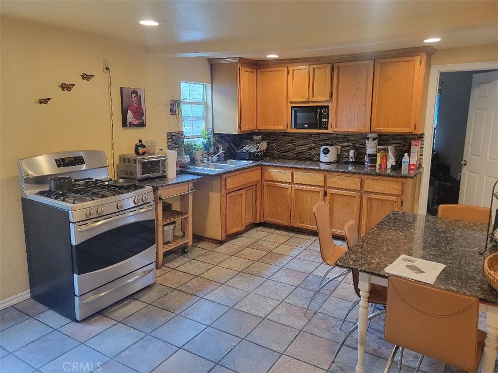 2335 Kellogg Court Altadena, CA 91001 - Photo 1 of 6 a kitchen with stainless steel appliances granite countertop a stove a sink and a refrigerator