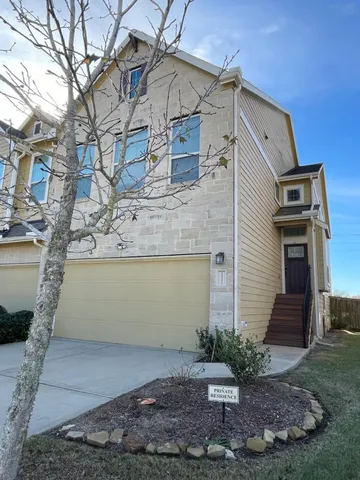 a view of a white house with a yard and plants
