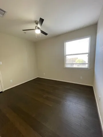 an empty room with windows and cabinet